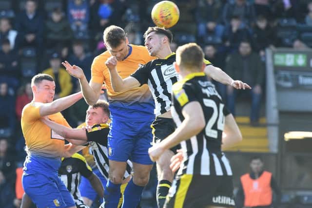 Stags' Ben Turner heads at County's goal.