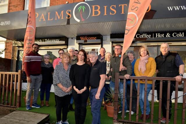 GloriaDe Piero, centre, is pictured with owners Deanna and Gary Thrall, front, and customers.