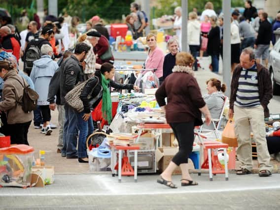 Bargain-hunters search a second-hand market (REMY GABALDA/AFP/GettyImages)