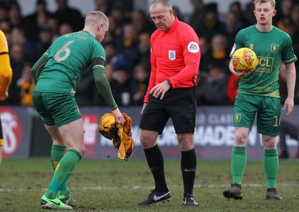 Picture by Gareth Williams/AHPIX.com; Football; Sky Bet League Two; Newport County v Mansfield Town; 9/2/2019  KO 15.00; Rodney Parade; copyright picture; Howard Roe/AHPIX.com; Mansfield's Neil Bishop clears blood of the pitch under instruction of referee Graham Salisbury following Danny Rose's head injury