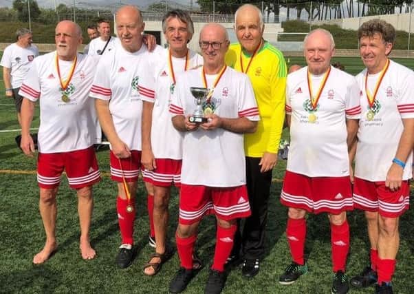Mansfield Senior Reds Over-50s walking football team after winning a trophy in Spain last year.