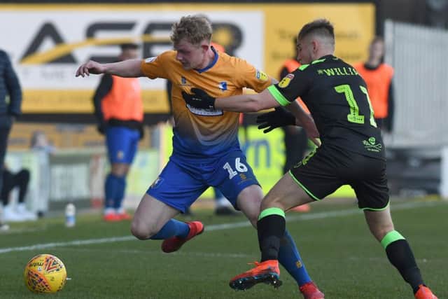 Mansfield's Williem Tomlinson battles with Forest Green's George Williams on his full debut.