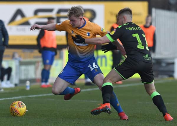 Mansfield's Williem Tomlinson battles with Forest Green's George Williams on his full debut.