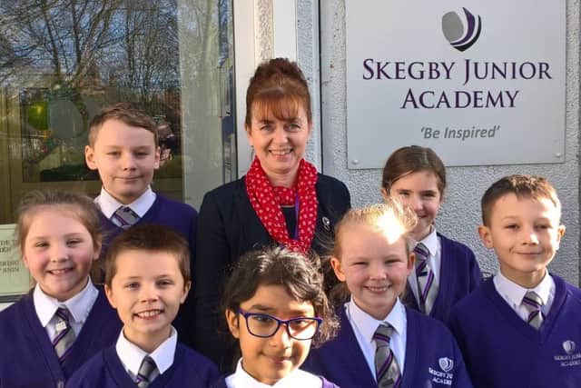 Happy children at Skegby Junior Academy with the principal, Pauline Marples.