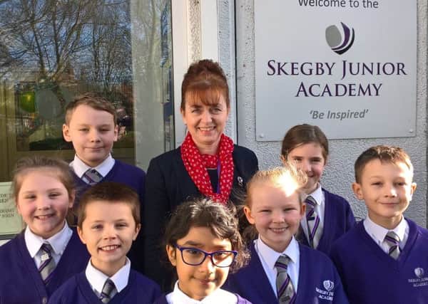 Happy children at Skegby Junior Academy with the principal, Pauline Marples.