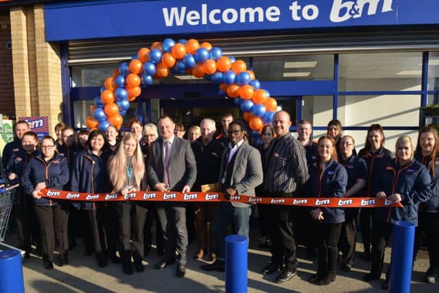 Official opening of new B&M store, Kirkby-In-Ashfield. Councillor Jason Zadrozny cuts the ribbon