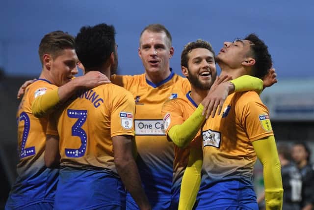 Mansfield's players celebrate a goal.