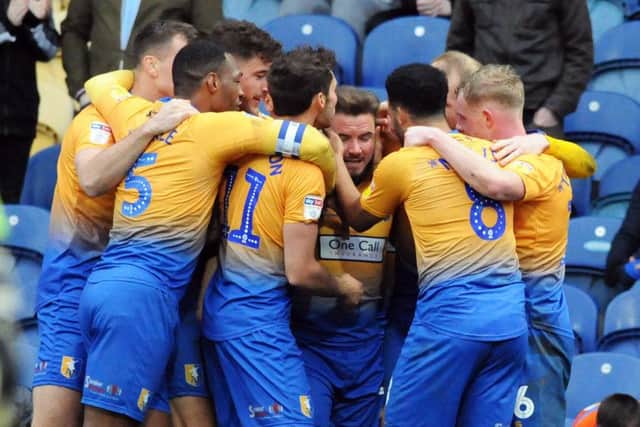 Mansfield Town v Cheltenham.
Alex MacDonald is mobbed by his team mates after scoring after just coming on as a late second half substitute.