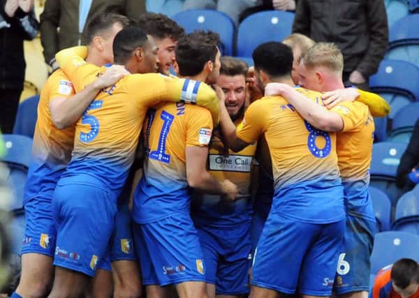 Mansfield Town v Cheltenham.        
Alex MacDonald is mobbed by his team mates after scoring after just coming on as a late second half substitute.