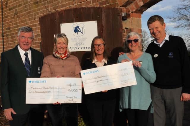 Cheques are presented to representatives of the charities by the club's general manager, Paul Thornton, and captains.