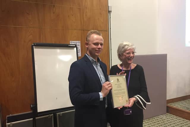Corey Spencer receiving his award from the Mayor