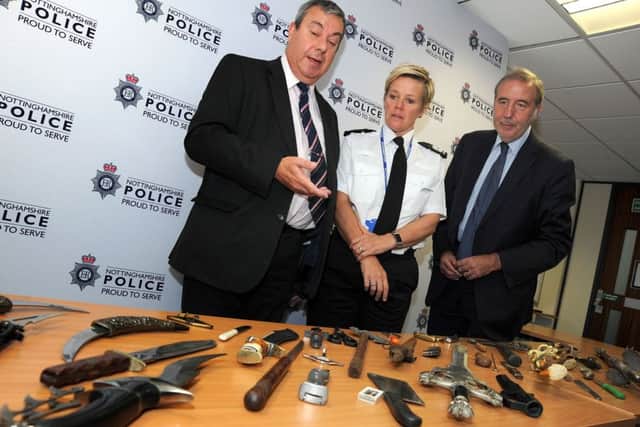 Police and Crime Commissioner Paddy Tipping, right, with Coun. David Ellis and Assistant Chief Constable Kate Meynell look over the handed in assortment of potential weapons following a recent knife amnesty.