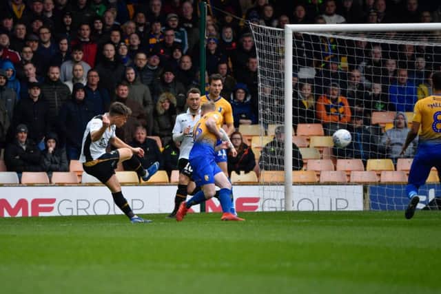 Port Vale's Luke Hannant curls a shot at the Mansfield Town goal.