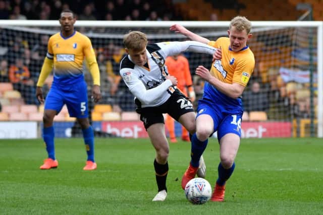 Mansfield Town's Willem Tomlinson tussles for the ball with Port Vale's Tom Conlon.