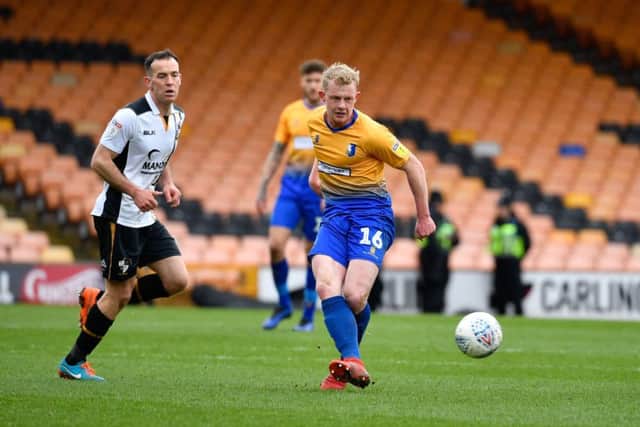 Mansfield Town's Willem Tomlinson plays a through ball.