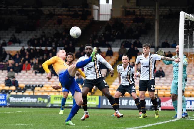 Mansfield Town's Neal Bishop hooks the ball back into the Port Vale box.