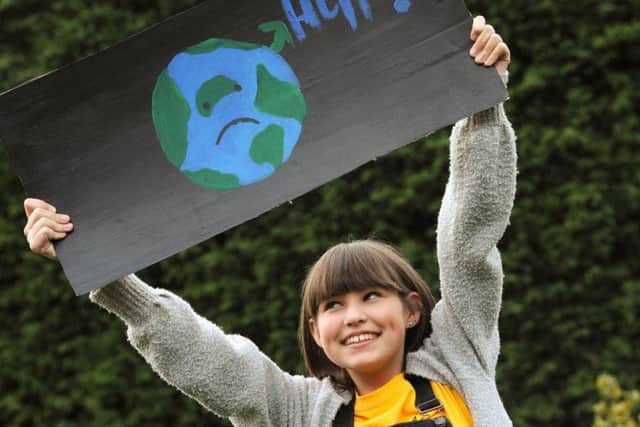 Poppy Asher, 12, with her climate change sign.