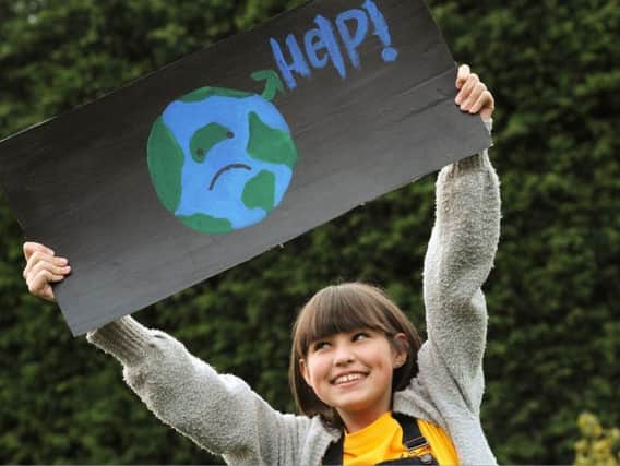 Poppy Asher, 12, with her climate change sign.