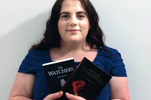 Sutton author Laura Birzulis with the first two books of her Watcher trilogy.