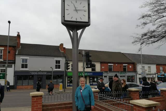 Christine next to the clock.