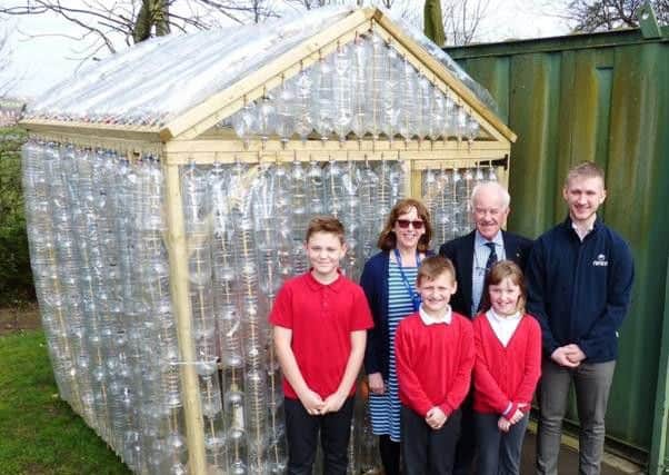 Sutton's Rotary Club Secretary Tony Lord, Croft School Headteacher Mrs Blount, and an apprentice from NMCM  who helped build the greenhouse.