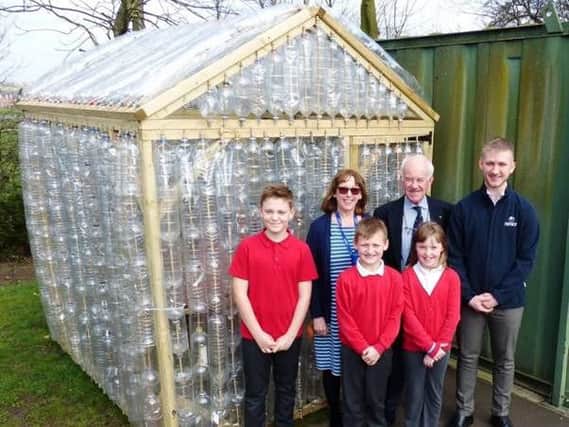 Sutton's Rotary Club Secretary Tony Lord, Croft School Headteacher Mrs Blount, and an apprentice from NMCM  who helped build the greenhouse.