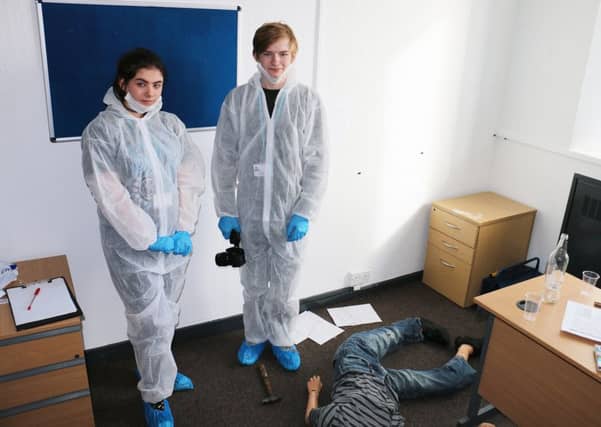 Students Megan Shorthouse and Taylor Roberts test their forensic skills at the West Nottinghamshire College 'murder scene'.