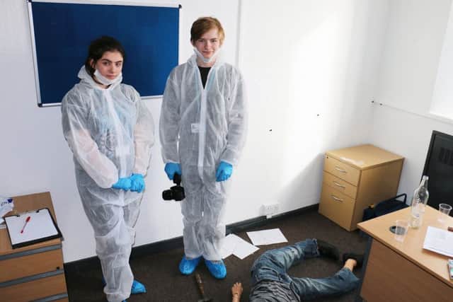 Students Megan Shorthouse and Taylor Roberts test their forensic skills at the West Nottinghamshire College 'murder scene'.