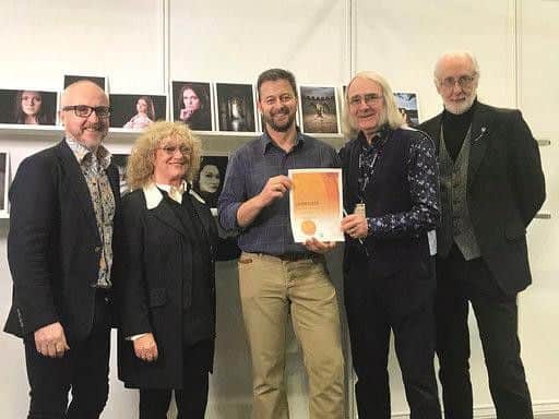Jarred Stubbings being presented with his qualification certificate by industry experts