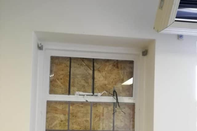 A boarded up window.