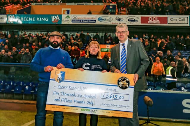 Paul Nyland presents his cheque to Cancer Research