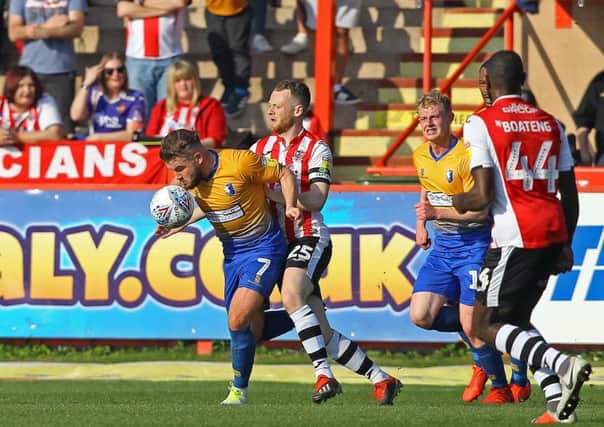 Picture by Gareth Williams/AHPIX.com; Football; Sky Bet League Two; Exeter City v Mansfield Town; 30/3/2019  KO 15.00; St James Park; copyright picture; Howard Roe/AHPIX.com; Stags' Alex MacDonald battles to bring the ball out of defence under pressure from Exeter's Jake Taylor
