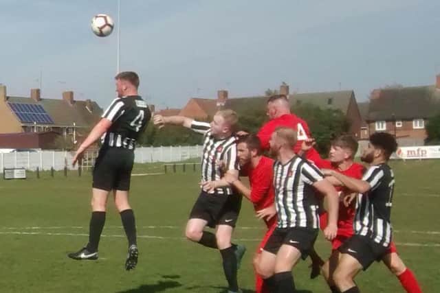Clipstone's Jason Gregory heads clear from an Ashby Ivanhoe corner. (PHOTO BY: Jim McIntosh)