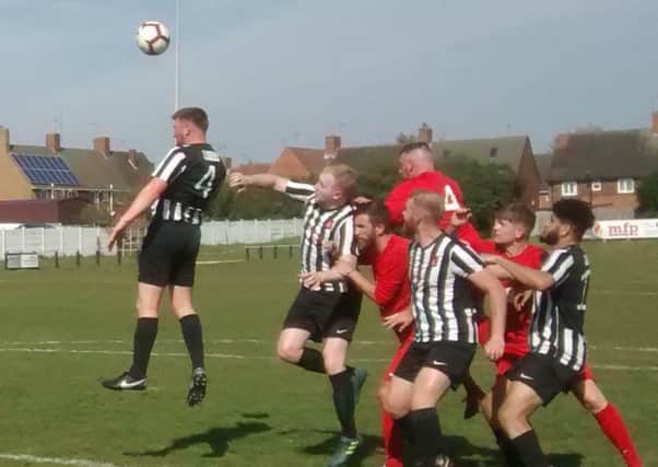 Clipstone's Jason Gregory heads clear from an Ashby Ivanhoe corner. (PHOTO BY: Jim McIntosh)