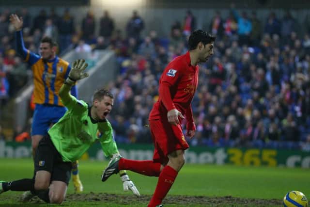 MANSFIELD, ENGLAND - JANUARY 06: Luis Suarez of Liverpool goes around Alan Marriott of Mansfield Town to score during the FA Cup with Budweiser Third Round match between Mansfield Town and Liverpool at One Call Stadium on January 6, 2013 in Mansfield, England. (Photo by Clive Mason/Getty Images)