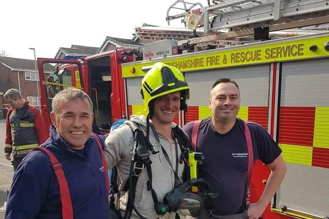 Electrician Chris Shaw with fire crews after extinguishing a fire in his neighbours kitchen