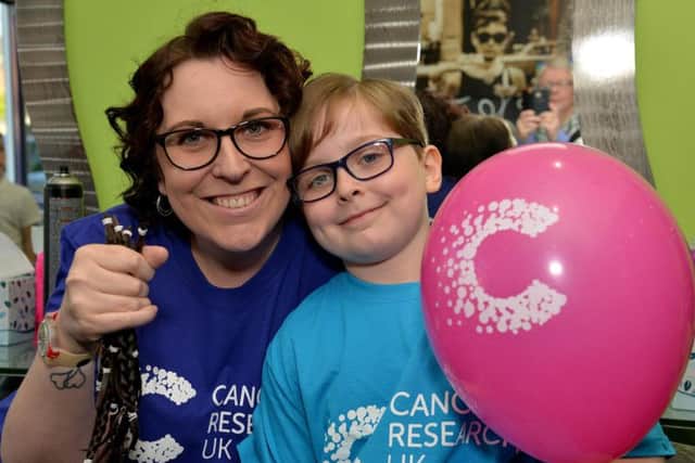 Esther Oliver, seven raising money for Cancer Research UK by having her hair cut, Esther is pictured with Mum Michala after her hair cut.