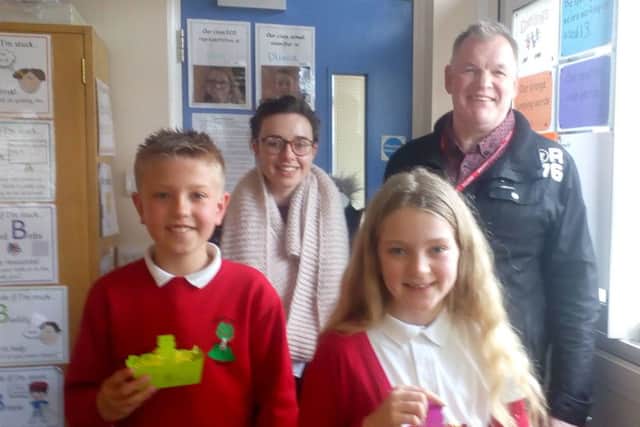 Rob Hurd and Beth Hutton from Life Church with two Berry Hill pupils with their Easter baskets.