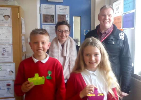 Rob Hurd and Beth Hutton from Life Church with two Berry Hill pupils with their Easter baskets.