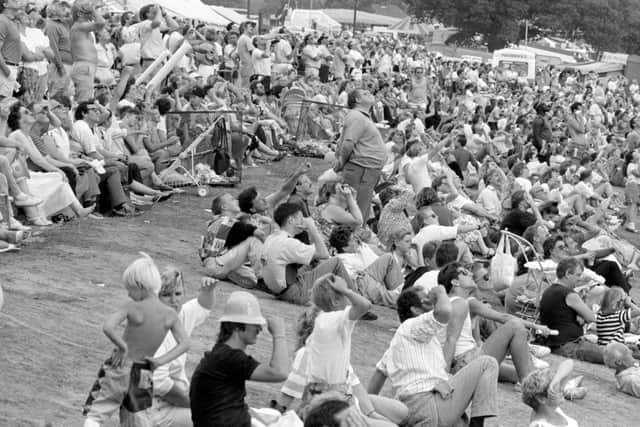 1990: The crowd are looking up at something at the Mansfield Show. Is it the Red Arrows, an aircraft or someone parachuting? Do you know?