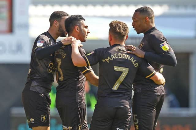 Mansfield's Mal Benning receives the congratulations after giving them the lead at Northampton.