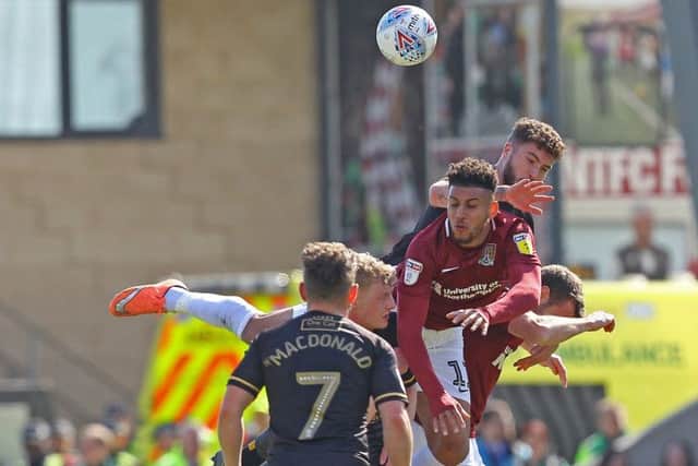 Ryan Sweeney leaps above Northampton's Daniel Powell.