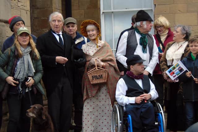 Marchers dressed in period costume .
