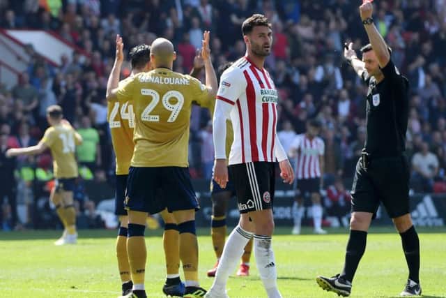 SHEFFIELD, ENGLAND - APRIL 19: Yohan Benalouane of Nottingham Forest is shown a red card by referee Andrew Madley during the Sky Bet Championship match between Sheffield United and Nottingham Forest at Bramall Lane on April 19, 2019 in Sheffield, England. (Photo by Ross Kinnaird/Getty Images)