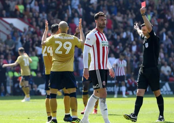 SHEFFIELD, ENGLAND - APRIL 19: Yohan Benalouane of Nottingham Forest is shown a red card by referee Andrew Madley during the Sky Bet Championship match between Sheffield United and Nottingham Forest at Bramall Lane on April 19, 2019 in Sheffield, England. (Photo by Ross Kinnaird/Getty Images)