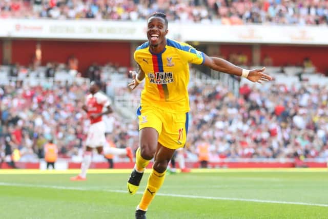 LONDON, ENGLAND - APRIL 21: Wilfried Zaha of Crystal Palace celebrates after scoring his team's second goal during the Premier League match between Arsenal FC and Crystal Palace at Emirates Stadium on April 21, 2019 in London, United Kingdom. (Photo by Warren Little/Getty Images)