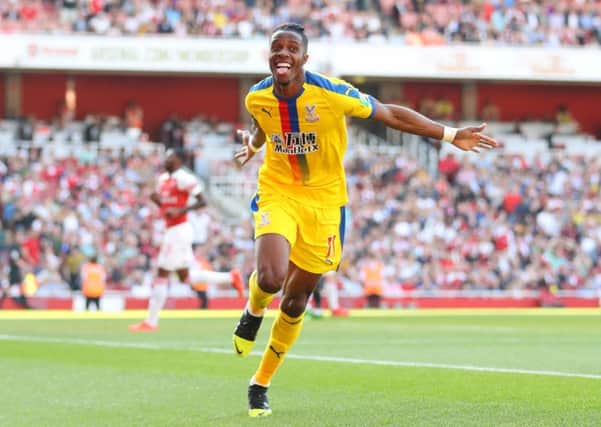 LONDON, ENGLAND - APRIL 21: Wilfried Zaha of Crystal Palace celebrates after scoring his team's second goal during the Premier League match between Arsenal FC and Crystal Palace at Emirates Stadium on April 21, 2019 in London, United Kingdom. (Photo by Warren Little/Getty Images)