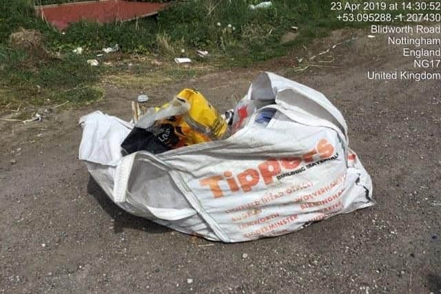 On the same road, a building materials bag has been dumped.