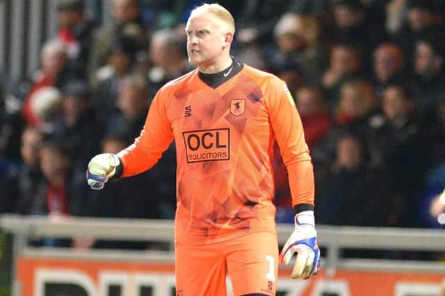 Conrad Logan is urging Mansfield Town to keep their cool.