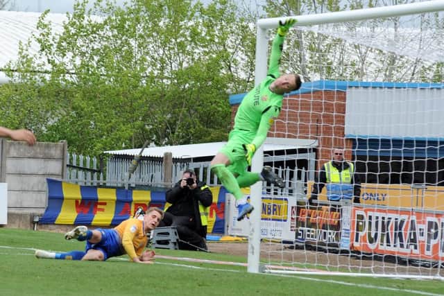 Danny Rose works the Stevenage 'keeper.